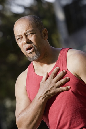 Man grabbing chest in pain.