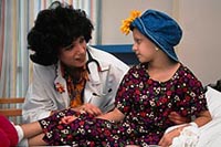 Picture of pediatric oncology patient being comforted by her physician
